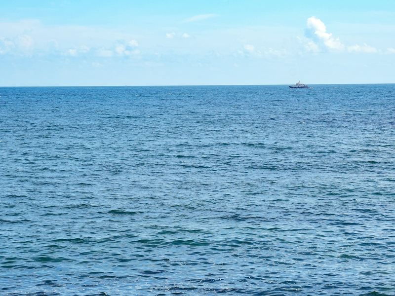 Calm blue open sea under a clear sky